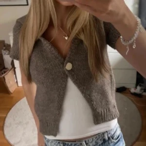 brun stickad kofta från Zara - Kortärmad brun stickad kofta från Zara som aldrig är använd