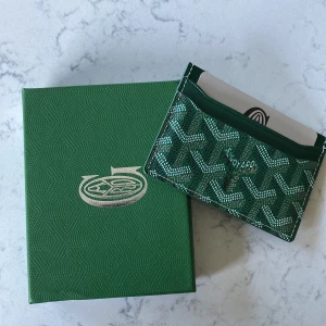 Grön Gy plånbok med mönster - Säljer en snygg grön plånbok från Gy med deras ikoniska grafiska mönster. Perfekt storlek för kort och enkel att ha med sig i fickan eller väskan. Kommer med originalask.