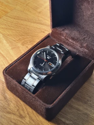 Seiko 5 Automatic - Seiko 5 SNK795 21-jewel automatic (self-winding)  Inköpt för runt 2500 SEK  Nyskick och fungerar felfritt. Endast använd vid 2-3 tillfällen. Har legat runt något år.  Håller tiden väl. +/- 10s per dygn  Diameter: ~37mm  Armband passar ~18-19cm (kan såklart justeras till mindre storlekar)  Fin ask medföljer (icke-orginal)