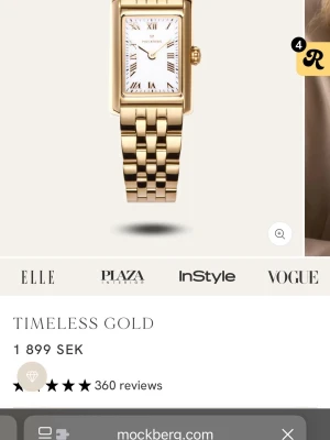 Mockberg Timeless Gold klocka - Snygg guldfärgad klocka från Mockberg med rektangulär urtavla och klassisk länkarmband i metall. Urtavlan är vit med romerska siffror och gulddetaljer. Perfekt accessoar för en stilren look.