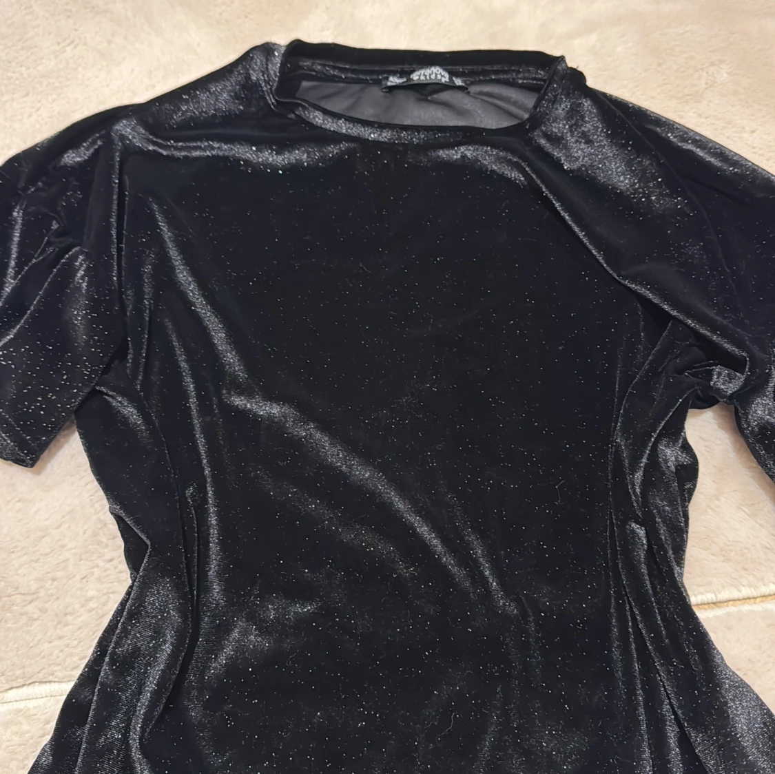 En svart glittrig tröja  - 1