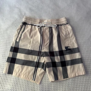 Burberry shorts - Snygga burberry badshorts som har en krämfärgad ton. Shortsen är i nytt skick ✔ Storlek: M ✔ Färg: Kräm ✔ Skick: Mycket bra (Knappt använda) 📦 Skickar inom 24h