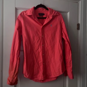 Korallfärgad skjorta från Ralph Lauren - Säljer en snygg korallfärgad skjorta från Ralph Lauren i bomull. Storlek S custom fit/slim fit