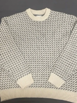  stickad tröja Vailent XL - Säljer en grovstickad tröja från Vailent i storlek XL. Tröjan är vit med svart mönster, har rund hals och ribbade muddar vid ärmslut och nederkant. Perfekt för dig som gillar en loose passform och vill ha en unik look med grafiskt mönster.