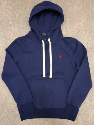 Ralph Lauren hoodie - Tja! Säljer denna riktigt snygga blåa Ralph Lauren hoodien i storlek L men den passar också M! Den är  helt ny, bara prövad. Priset är ej hugget i sten! Tveka inte att kontakta vid frågor eller funderingar! 