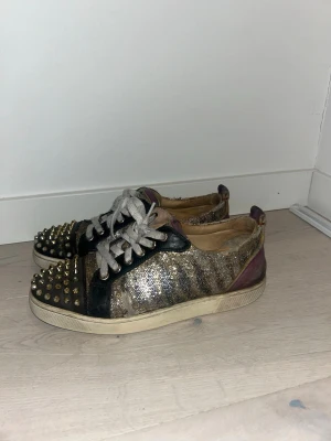Christian louboutin sneakers - Säljer ett par unika sneakers från christian louboutins med silverfärgat tyg. Svinsnygga men  slitna så därav priset! Ascoola! Passar inte mig längre men rekommenderar till varje outfit!✌🏼
