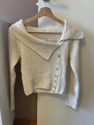 Vit stickad kofta med sned krage - Säljer en vit stickad kofta från Zara med unik sned krage och dekorativa pärlemorknappar🥰 använt två gånger och båda gångerna fått komplimanger!