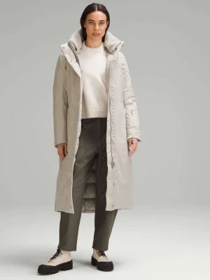 LULULEMON Snow Warrior 600-Down-Fill Long Parka - Raw Linen - The snow wear parka from lululemon is made with waterproof fabric to keep you warm and dry during stormy winter weather. Designed for a classic fit with room for layering, this long parka features a removable textured fleece collar, unsnap side slits for added mobility, and straps on the inside to wear the jacket like a backpack. It also features zippered exterior pockets with a hidden phone sleeve, two zippered pockets on the inside, another on the outer sleeve, a cinchable waist, and a hood.