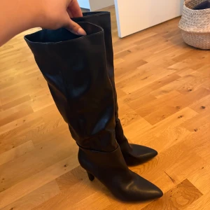 Svarta stövlar med klack och spetsig tå - Svarta stövlar med klack och spetsig tå. Aldrig använda, lapp kvar. Nypris ligger på 999kr. Stl 40 men passar mig som har 38,5-39. Fler bilder skickas vid önskemål ☺️