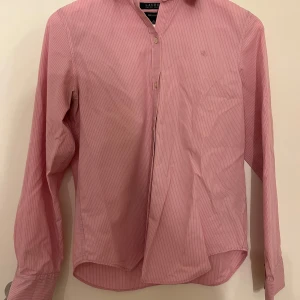 Rosa Ralph Lauren skjorta - - Ralph Lauren - Storleken S                                                                                                                       - Mycket bra skick                                                          - 100% bomull                                                   Väldigt fin rosa Ralph Lauren som passar till både formella tillfällen och vardags outfiten, den är även non iron vilket innebär att den är  enkel att ta hand om. Svarar gärna på frågor såsom bättre bilder💕