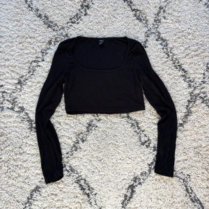 croppad långärmad topp - En så himla skön cropped svart topp med urringning, ett av de absolut skönaste materialet jag haft på mig!!