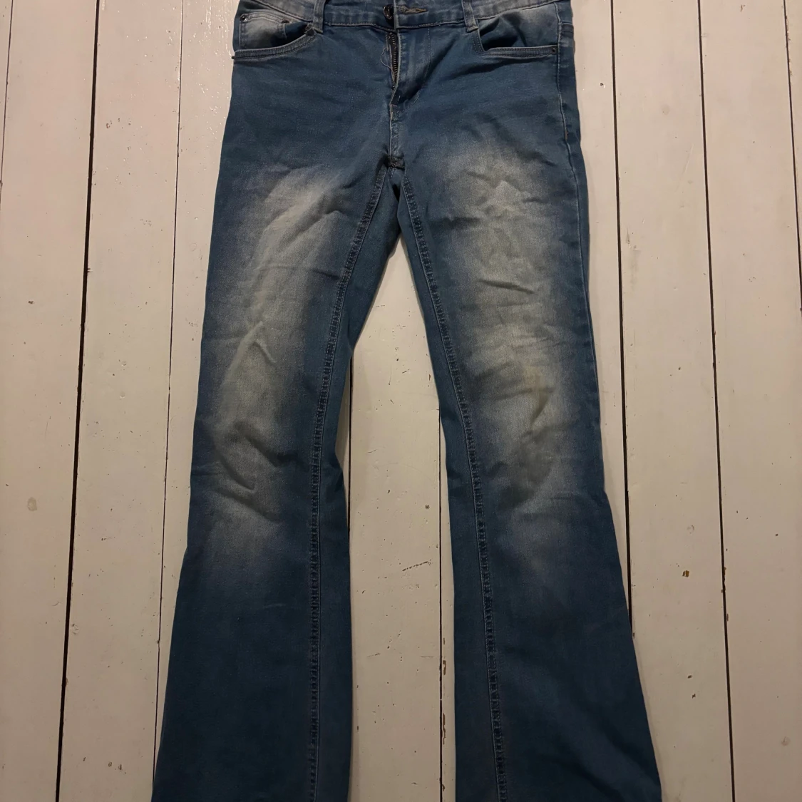 Blå bootcut jeans med slitningar