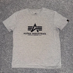Grå Alpha Industries t-shirt M - Snygg grå t-shirt från Alpha Industries i storlek M. Tillverkad i mjuk bomull för skön känsla. 10/10 skick, hör av dig vid frågor eller behov av fler bilder.