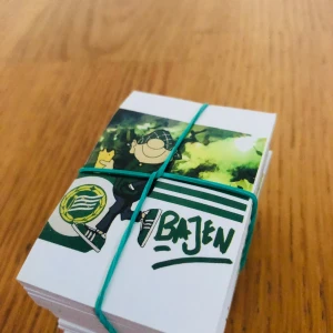 Bajen klibbor  - En bunt med små kort eller stickers med Bajen-tema, perfekt för dig som älskar Hammarby och vill visa ditt stöd på ett kreativt sätt. Färgglada illustrationer och klubbens emblem gör dem till ett måste för alla unga supportrar och samlare.