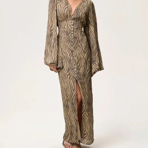 Zebramönstrad Adoore klänning - Säljer min zebramönstrade adoore klänning som jag använt ändast fåtal gånger. Den är som helt ny förutom att två knappar har gått upp längst ner på klänningen (se sista bilden) men detta är inget som är svårt att fixa ihop om man vill det. I övrigt är den som ny och superfin klänningen som tyvärr inte kom så mycket till användning bara. 🫶🏽