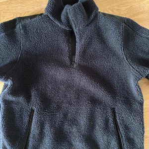 Mörkblå fleecejacka Sail Racing - Säljer en mörkblå fleecejacka från Sail Racing med half zip. Jackan har två sidofickor med dragkedja och förstärkta axelpartier i svart tyg. Perfekt för kalla dagar och riktigt skön att ha på sig. Köpt förra vintern för 1800kr, pris kan diskuteras!