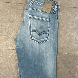 Ljusblåa Replay jeans - Ett par stilrena replay jeans som är i fint skick till ett riktigt bra pris. Storleken på dom är W30 L34 och är anbass modellen. Finns inga defekter eller skador med jeansen.