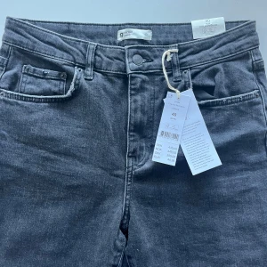 Jeans offblack flare storlek 40 - Snygga jeans från Gina Tricot, oanvända med alla etiketter kvar. Modell Ylva, kick flare (dvs ankellång) Bomull med  lite stretch. 