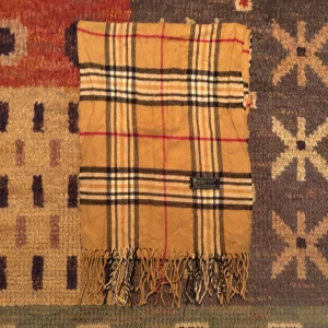 Vintage Burberry Halsduk - -Riktigt bra skick. Nypris på dessa ligger på runt 5000kr, vilket gör detta till ett sjukt bra pris! Halsduken är gjord i Lamull, och är perfekt inför hösten och den kommande vintern. Anledningen till att det står ”Burberry’s” och inte ”Burberry” på lappen är eftersom halsduken är från några år tillbaka, innan de bytte namn! Om du har någon fråga är det bara att skriva till mig. /elgnce (5)