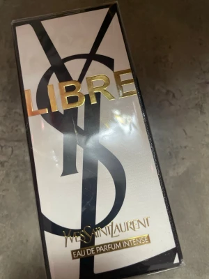 Yves Saint Laurent Libre EdP Intense - Yves Saint Laurent Libre Eau de Parfum Intense är en lyxig parfym i en elegant rektangulär glasflaska med gulddetaljer och svart logotyp. Doften är intensiv och modern, perfekt för dig som vill sticka ut med en exklusiv signaturdoft.