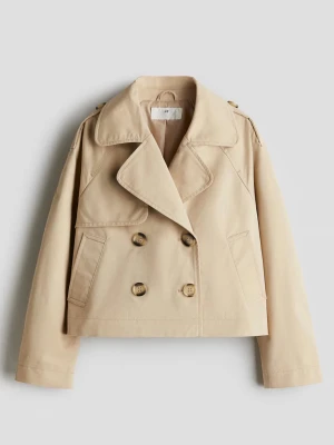 Kort beige trenchcoat med dubbelknäppning - Stilren kort trenchcoat i beige med breda slag, axelklaffar och dubbelknäppning framtill. Jackan har två snedställda fickor och är tillverkad i ett slätt bomullstyg. Perfekt för en trendig och avslappnad look. Storlek 164