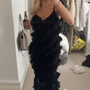 Svart långklänning med volanger - Säljer den här virala svarta långklänningen med volanger från NAKD som är slutsåld. Den är använd en gång så är som ny. Säljer för den inte kommer till användning🥰