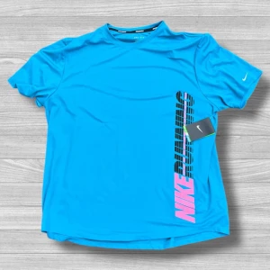 Blå Nike Dri-Fit t-shirt XL - Snygg blå t-shirt från Nike i Dri-Fit material, perfekt för löpning. Stor tryckt logga med 'NIKE RUNNING' i svart och rosa längs sidan. Kortärmad och med rund hals. Lätt och ventilerande polyester som håller dig fräsch under träningen.