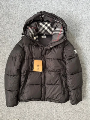 Burberry black puffer jacket - Unisex. Size M and very true to size. Its brand new with tags