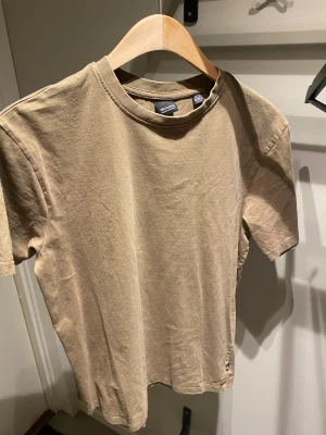 Beige t-shirt från ONLY & SONS - En basic beige t-shirt från ONLY & SONS i mjuk bomull. Klassisk rund halsringning och korta ärmar. Perfekt för en clean och avslappnad stil. Passar dig som gillar enkla plagg med snygg passform.