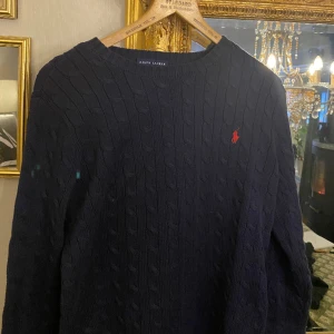 Stickad Ralph Lauren tröja - Jätte fin stickad  Ralph Lauren tröja som är helt oanvänd i färgen mörkblå. Säljer pga att den var för liten. Xl men Storleken är liten så passar även large. Pris går att diskuteras