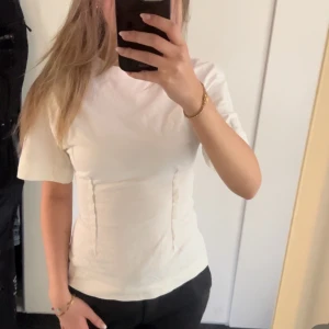 Vit t-shirt - slutsåld tshirt från H&M som är figursydd. super fin men ändå enkel liksom. strl XS, aldrig använd.