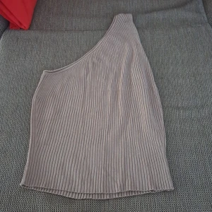 One shoulder top - This is an elegant one shoulder top from bikbok. Never worn before. Selling because it big on me. 100% new. 
