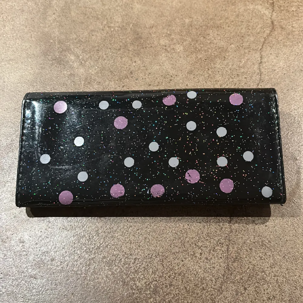 Glittrig plånbok med Hello Kitty-motiv. Söt rosa rosett. Fack för kort, mynt samt kvitton och pengar. Mått 18,5x9 cm. . Väskor.