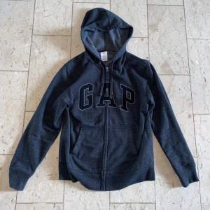 En grå Gap zip hoodie i storlek S🔥 Fint skick och stilig till sommaren! Kontakta vid minsta fråga🔔