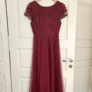 Vinröd balklänning - Väldigt fin balklänning. Använd en gång och i bra skick. Den är lite förkortad så att den skulle passa mig som är 160 cm. 