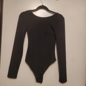 Svart body - Svart body från gina med djup öppen rygg. Helt oanvänd, säljes pga för liten. Storlek xs 