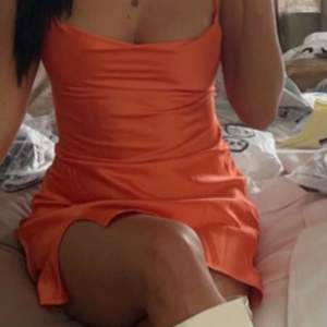 Orange klänning i satin, använd en gång 