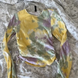 Tie dye tröja - Denna färgglada tröja med snören på vardera sida av midjan, är i storlek S.  Tröjan är i jätte bra skick🙌