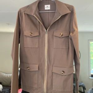 John Henric overshirt - Säljer denna beige/gråa overshirten i ett 10/10 skick. Bara använd två gånger. Priset kan diskuteras vid snabb affär.