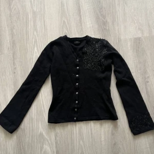 Kofta med detaljer - En superfin kofta som jag inte använder längre.  Den är köpt från sellpy. Står ingen storlek men jag skulle säga XS/S. Vill förvarna att den kan kännas lite stickig ibland!