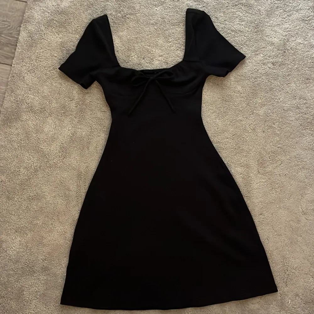 Supersöt svart klänning med en liten rosett😇den är helt oanvänd (endast testad) finns inga defekter på den.. Klänningar.