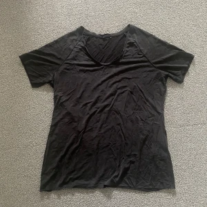 T-shirt - Svart t-shirt i skönt och lätt material som påminner om träningstyg.