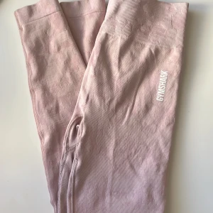 Gymshark Adapt Camo Seamless Ribbed Leggings  - Jag säljer ett par snygga och bekväma träningstights från Gymshark som är i bra skick.   De är ljusrosa camo med scrunch.