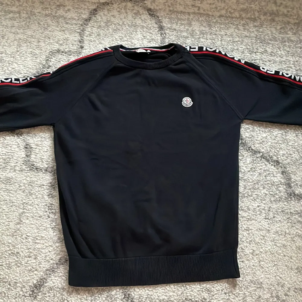 Selling a black Moncler sweater, it got a small hole.. Hoodies.