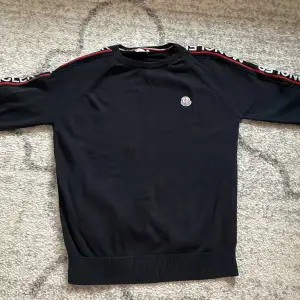 Selling a black Moncler sweater, it got a small hole.