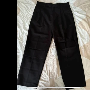 Holzweiler Eleganta Chinos - Hej! Jag har dessa lyxiga Holzweiler-byxor tillgängliga. De är i utmärkt skick, endast använda några gånger. Om du har fler frågor, tveka inte att fråga!  Midjan är 47 cm och längden, från midjan till fållar, är 105 cm.