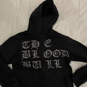 Rinstone Hoodie  - Text: THE BLOOD BULL 