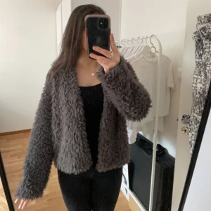 Fluff jacka i grå - Fin fluffig jacka/kofta från Gina, använd en gång! Sitter som M/S men är XL!