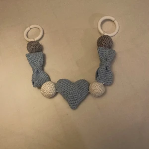 Barnvagnshänge - Virkat barnvagnshänge, med rosetter och ett hjärta