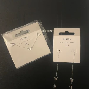 Äkta silver set, örhängen och armband med fjärilar - Helt nya smycken i äkta silver (925). Ett armband och ett par örhängen.  Nypris 500kr